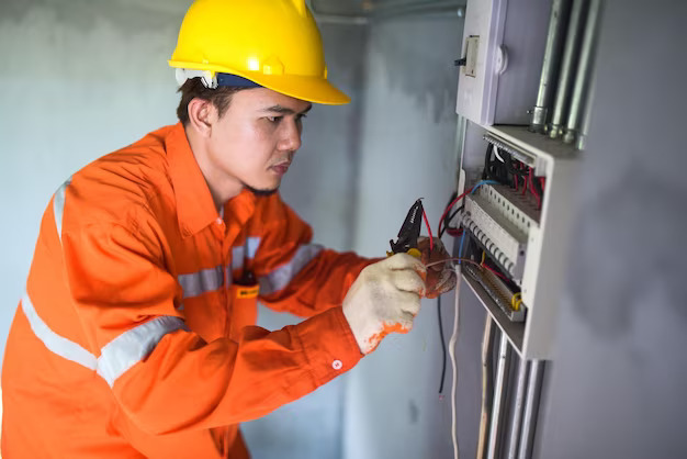 side-view-handsome-asian-electrician-repairing-electrical-box-with-pliers-corridor_697211-102